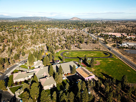 drone photo over high desert middle school in southeast bend looking north towards pilot butte