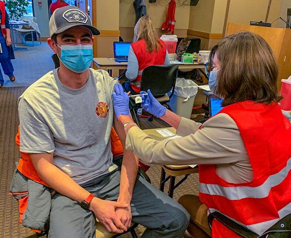 Fire Department employee receiving COVID-19 vaccine.