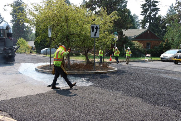 Crews resurfacing a roadway