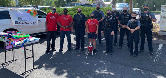 Group giving out backpacks at Welcoming Week Event