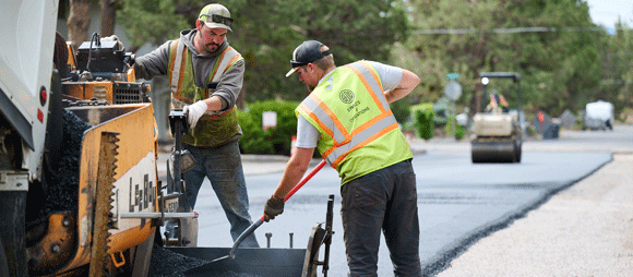 A crew paving a road.