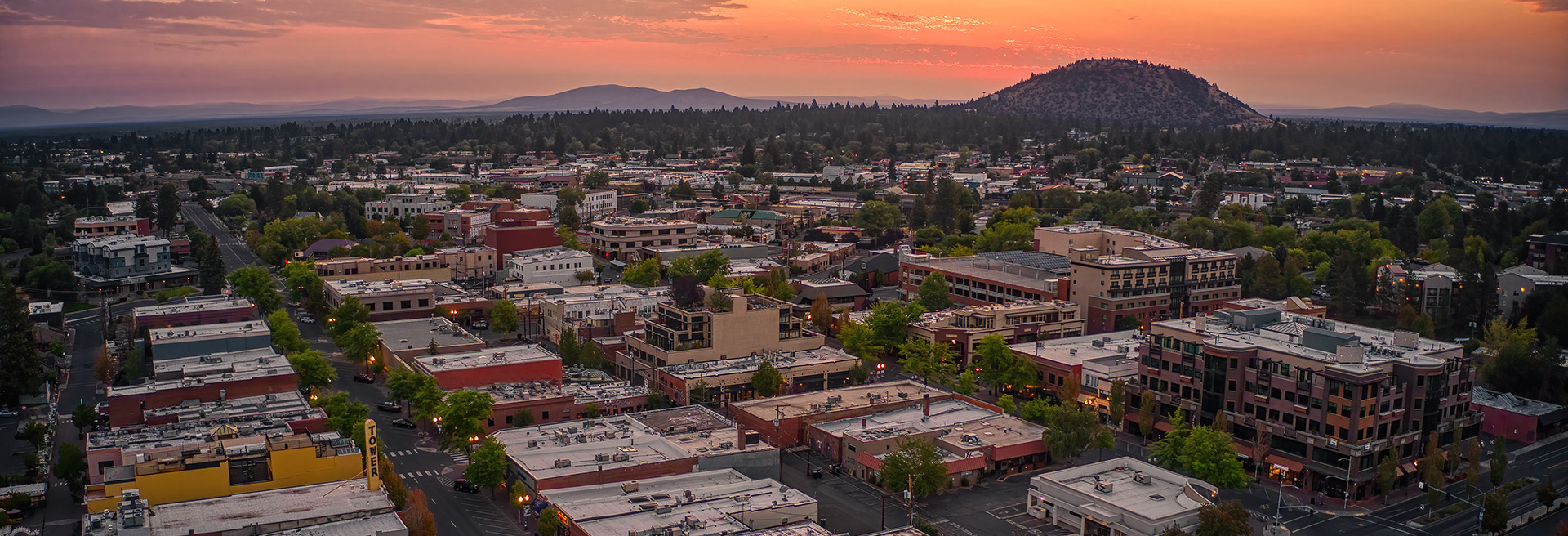Overlooking Bend at sunrise to the East. Pilot Butte in the mid-ground, businesses and houses throughout.