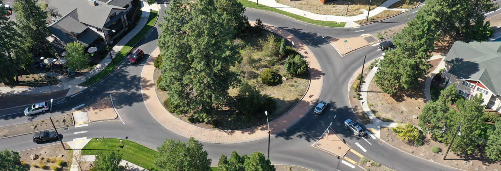 Roundabout traffic circle from overhead with trees in the center.