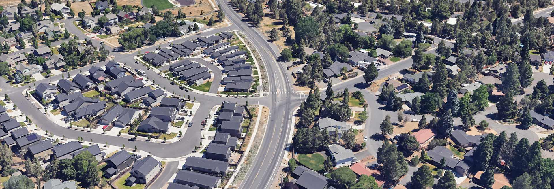 Drone shot of project area, Bulter Market Rd and Wells Acres Rd. intersection. Houses and trees surround the streets.