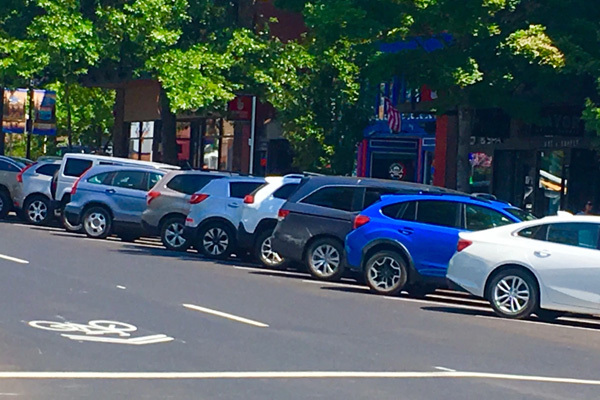 Cars parked in front of businesses in downtown Bend.