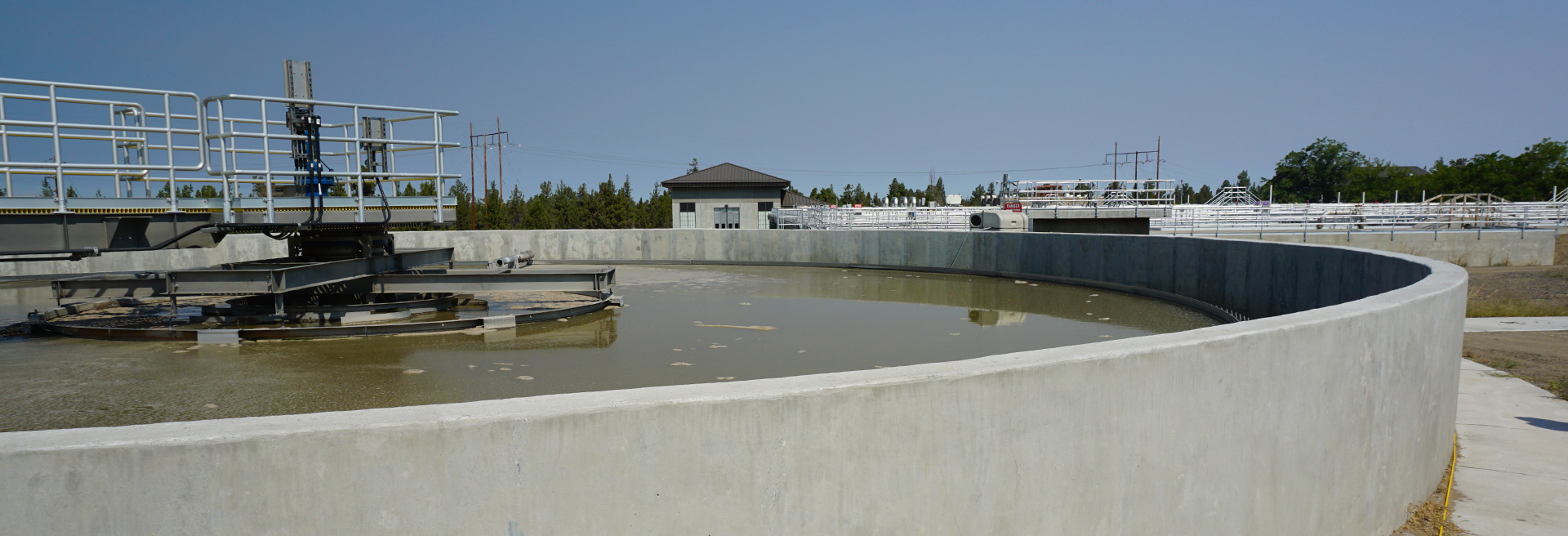 Water reclamation tank. Cement circle with wastewater inslide and equipment above.
