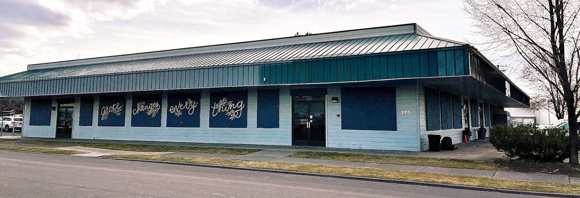 Lighthouse Navigation Center Building. Is one story tall, light green in color. 