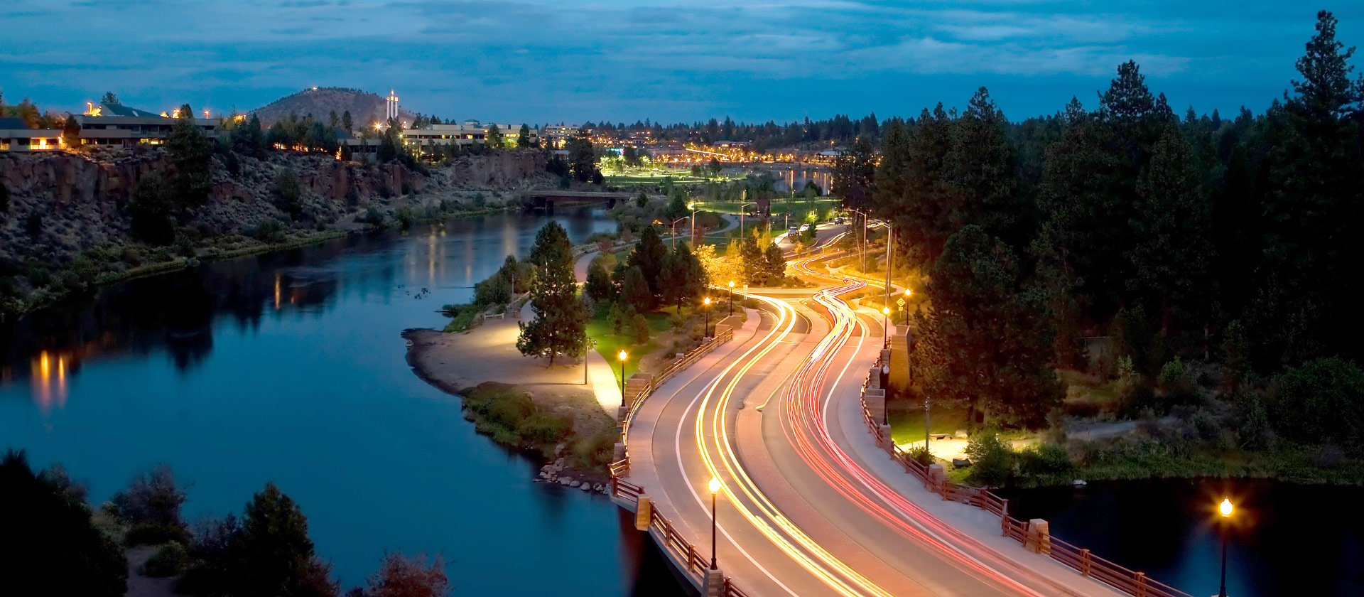 Trails of light from cars as they pass over Reed Market Bridge at night. Photography: ©2008 Dustin Mitsch / Alpen Exposure