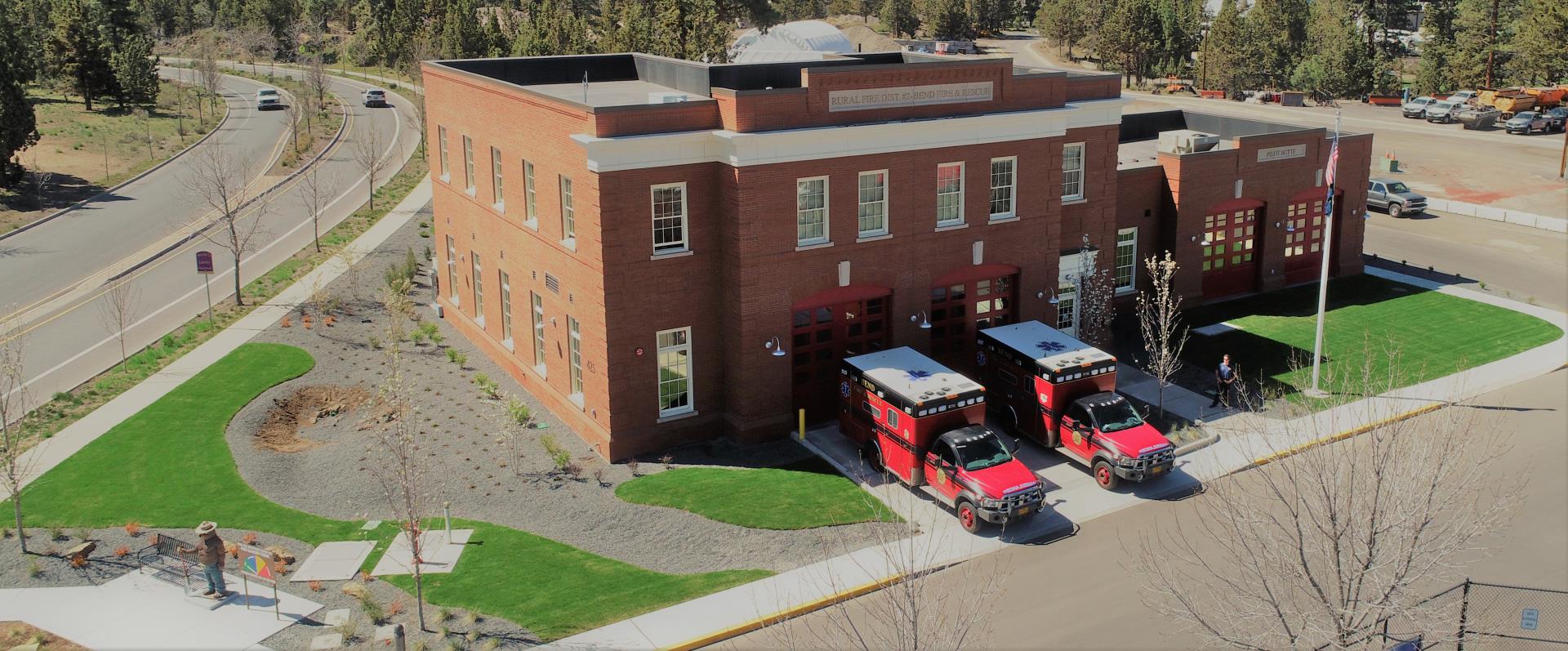 Image of Pilot Butte Fire Station with two ambulances